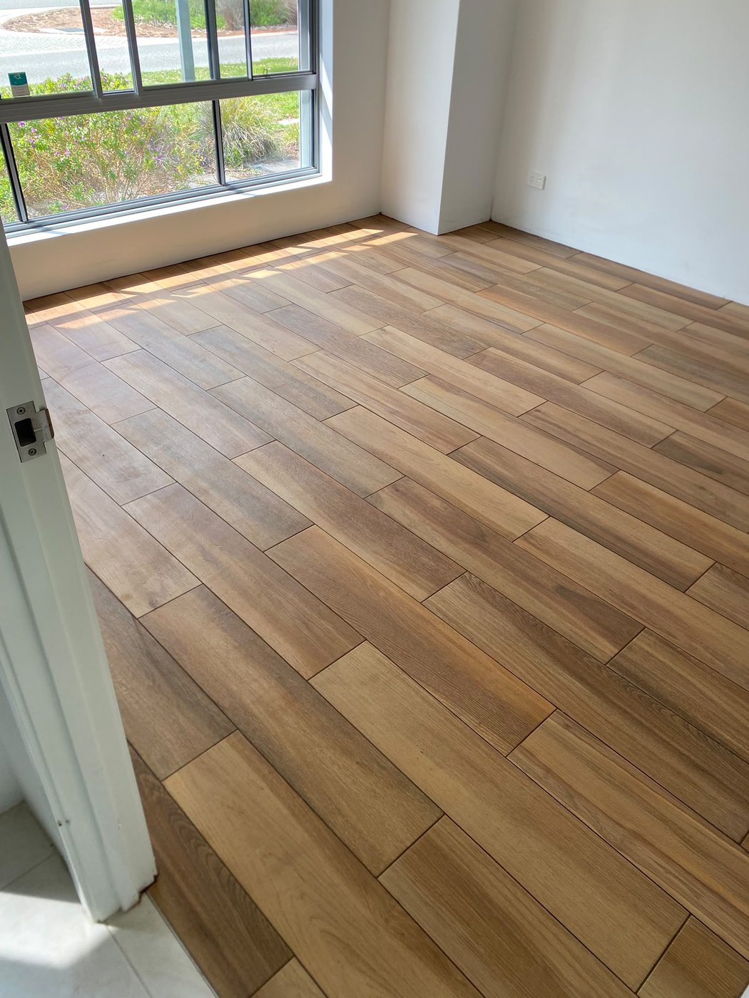 Timber-look tile flooring in a bright Perth living space
